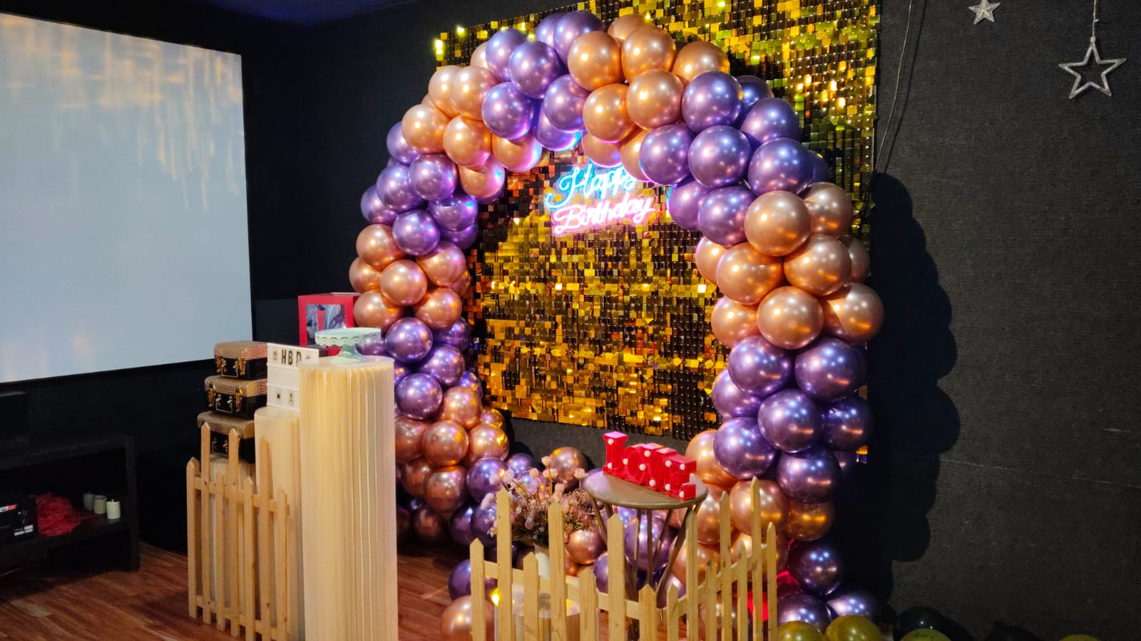 Gold and purple balloon arch in a private theatre